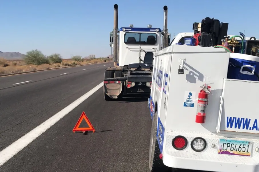 ATAC mobile technician performing 24/7 emergency roadside truck repair on Arizona highway