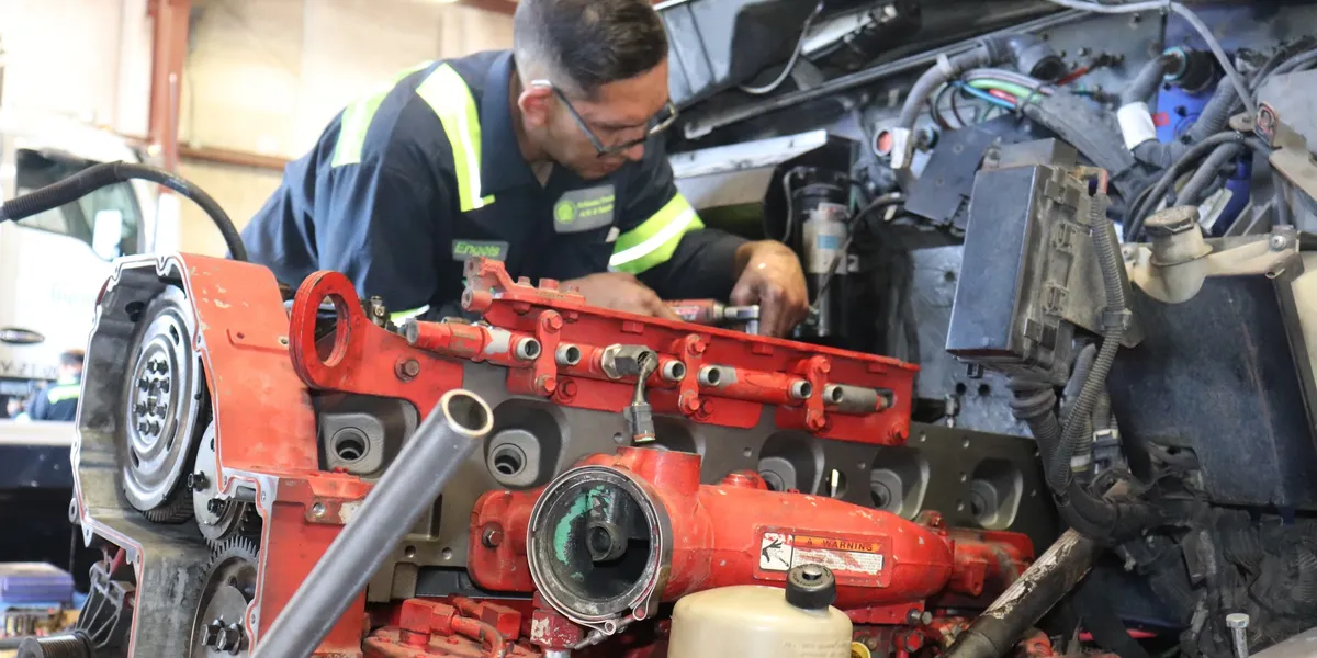 ATAC diesel technician performing engine repair on a commercial truck at the Phoenix shop
