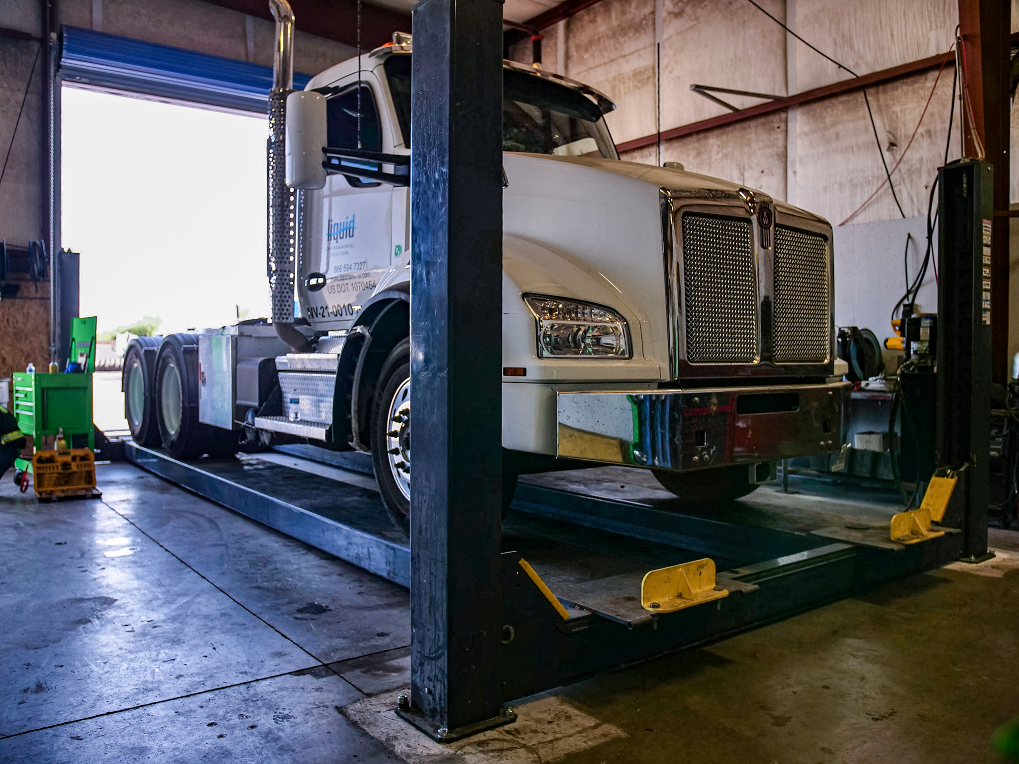 Commercial truck raised on heavy-duty lift for undercarriage repair at ATAC Phoenix shop