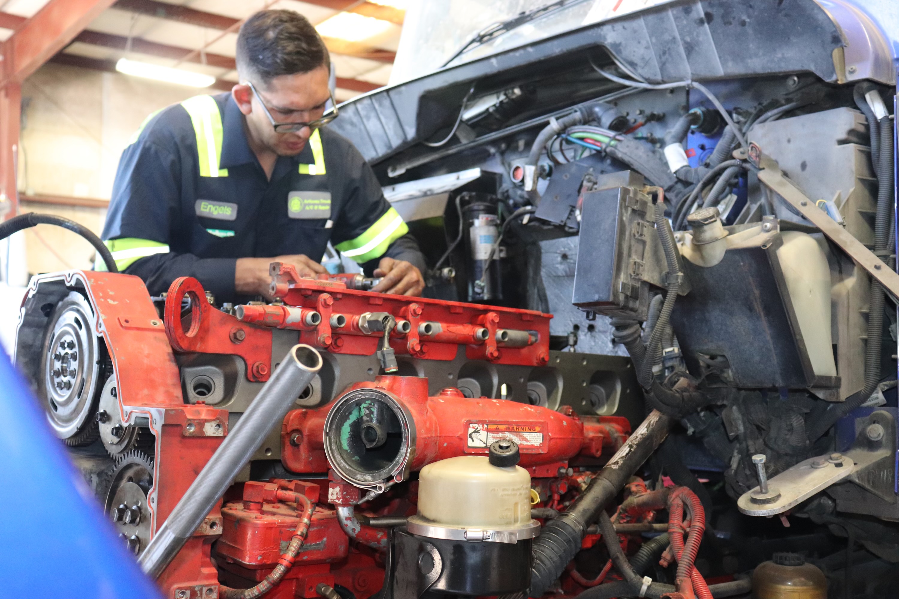 ASE certified diesel mechanic performing engine rebuild at Arizona Truck AC and Repair shop in Phoenix